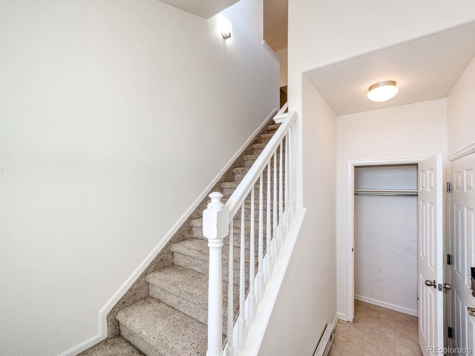 5255 Memphis Street, Unit 122 Denver, CO 80239 - Photo 4 of 26 a view of a hallway with staircase