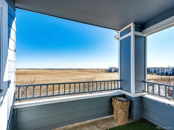 a view of a balcony with lake view and wooden floor