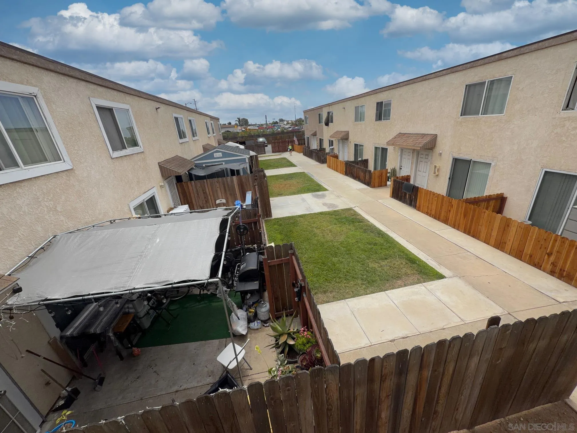 1054-1058 Outer Road San Diego, CA 92154 - Photo 5 of 14 a view of a patio with table and chairs with wooden floor and fence