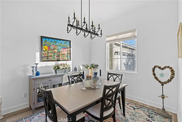 a view of a dining room with furniture and chandelier