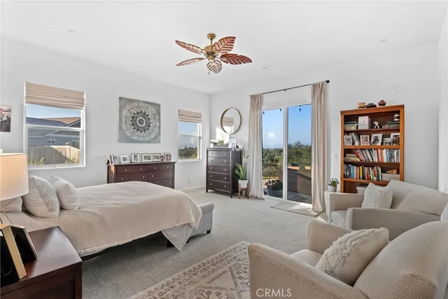 a bedroom with a large bed and a couch