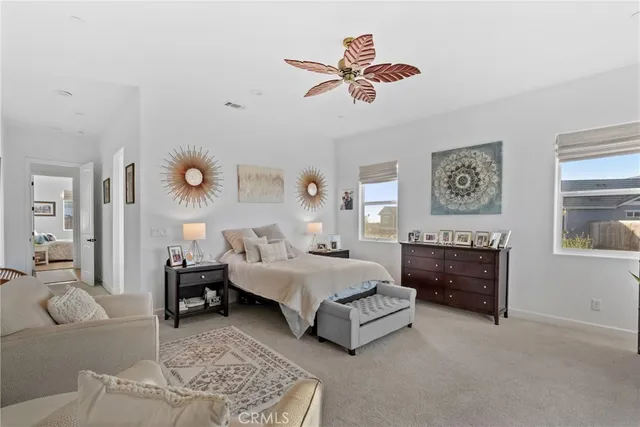 a spacious bedroom with a bed couch and a window