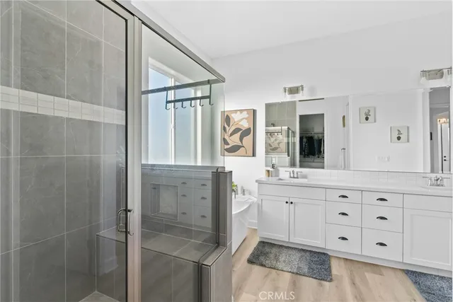 a spacious bathroom with a granite countertop sink a mirror and a shower