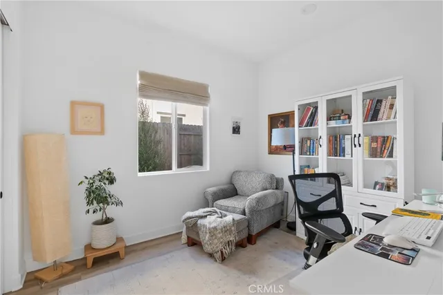a work room with furniture and a potted plant