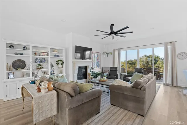 a living room with furniture a fireplace and a large window