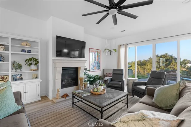 a living room with furniture a flat screen tv and a fireplace