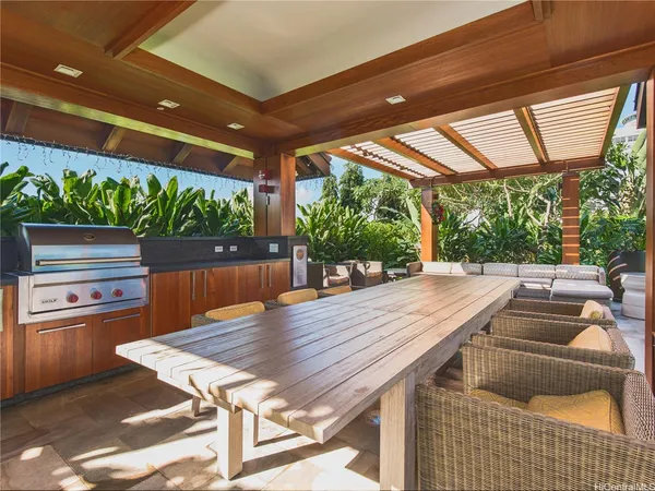 a patio with water view fountain with wooden floor and outdoor seating