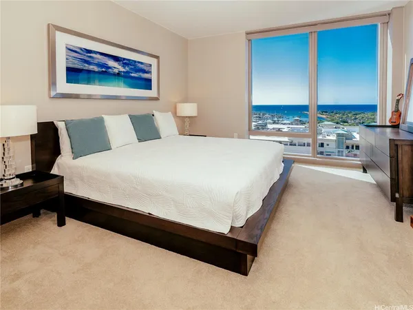 a large bed sitting in a bedroom next to a window