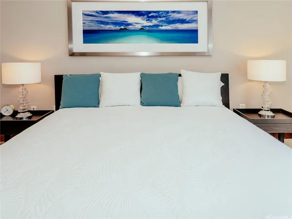 a bedroom with a bed and wall painting