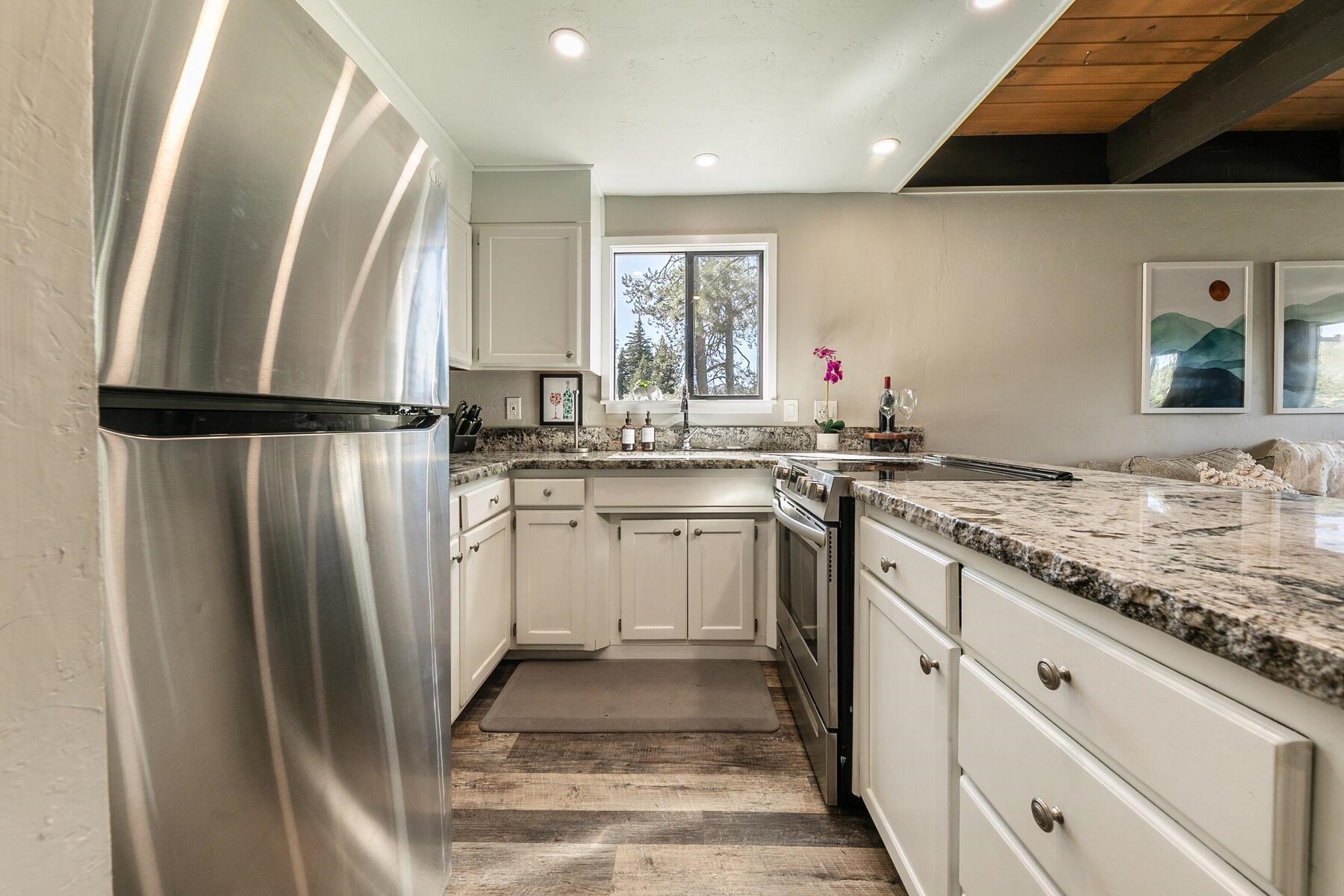 14395 South Shore Drive Truckee, CA 96161 - Photo 14 of 25 a kitchen with white cabinets and refrigerator