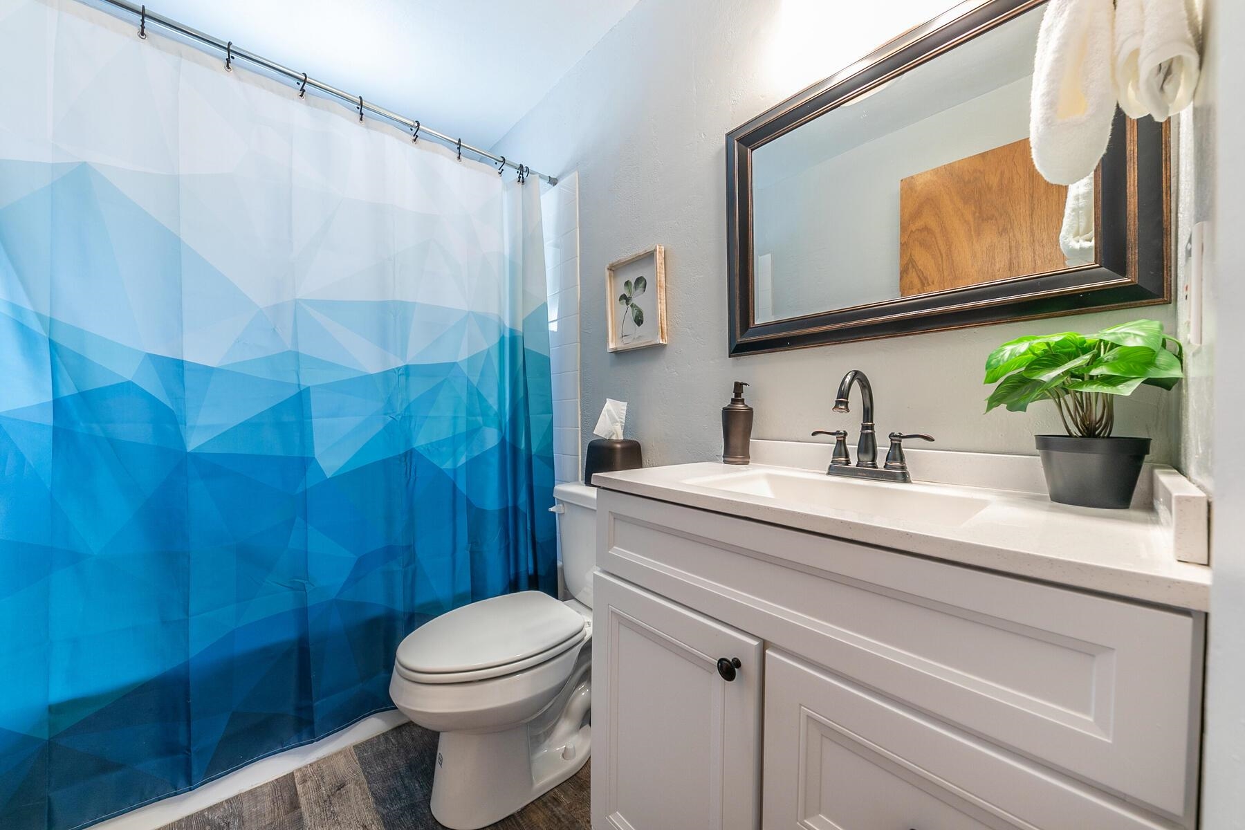 14395 South Shore Drive Truckee, CA 96161 - Photo 17 of 25 a bathroom with a sink a toilet and shower curtain