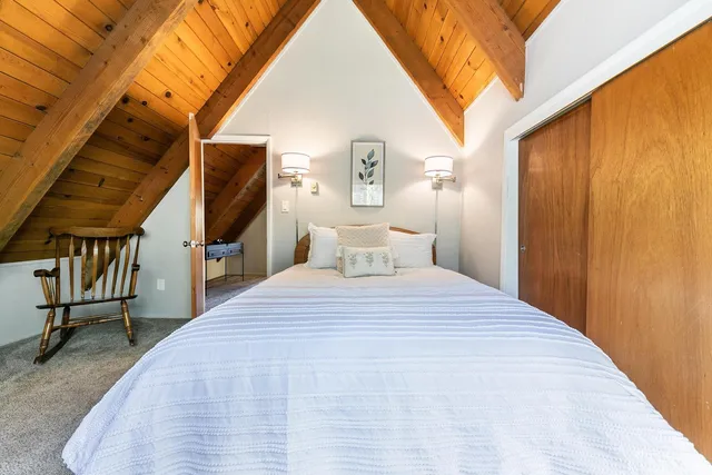 a bed sitting in a bedroom next to a window