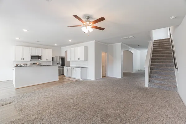 a view of an empty room with a ceiling fan