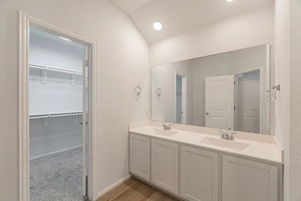 a spacious bathroom with a double vanity sink shower and a mirror