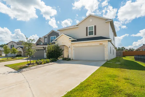a front view of a house with a yard and garage