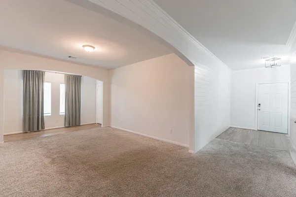 a view of an empty room and wooden floor