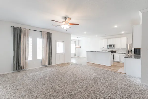 a view of a kitchen with a sink and a refrigerator