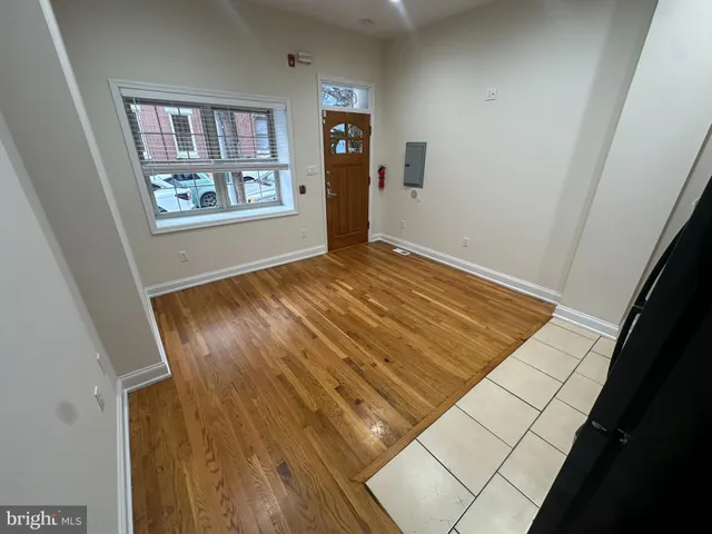a view of an empty room and wooden floor