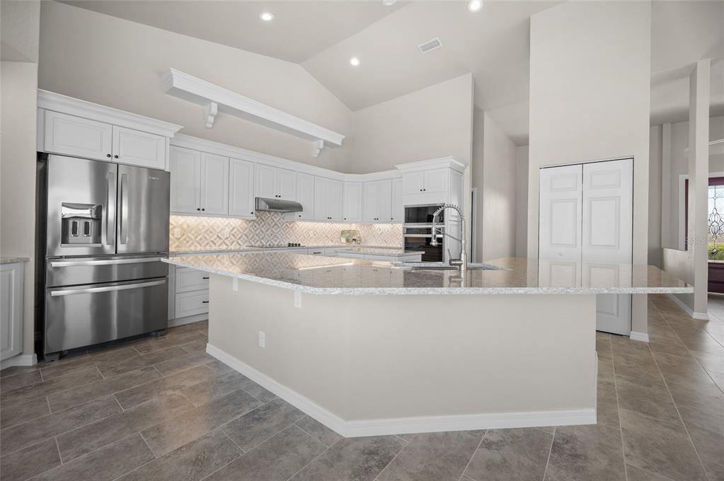 1950 Arkansas Avenue Englewood, FL 34224 - Photo 13 of 52 a kitchen with stainless steel appliances granite countertop a refrigerator and a stove