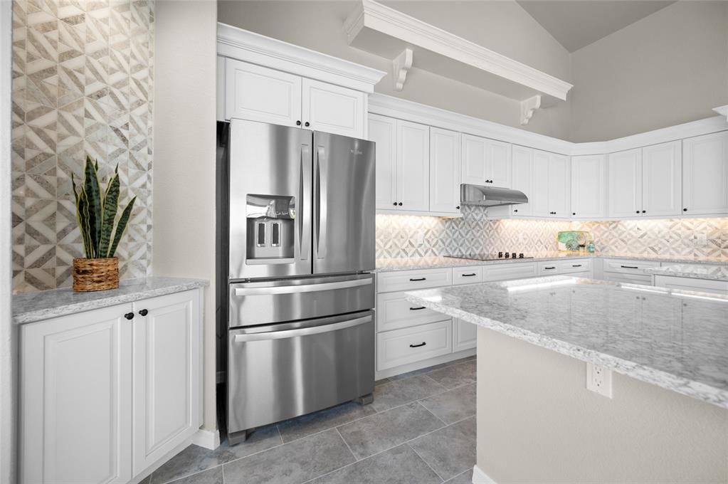 1950 Arkansas Avenue Englewood, FL 34224 - Photo 17 of 52 a kitchen with stainless steel appliances white cabinets and a refrigerator