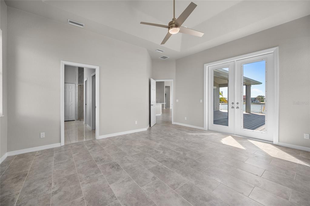 1950 Arkansas Avenue Englewood, FL 34224 - Photo 19 of 52 an empty room with fan and windows