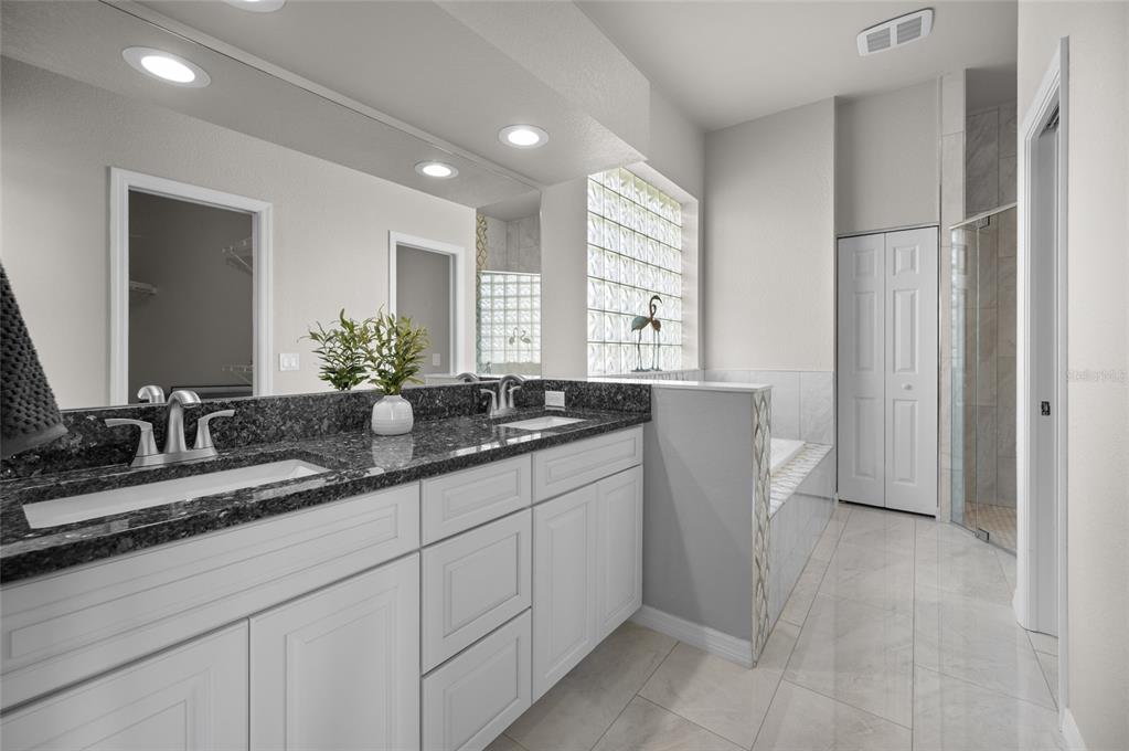 1950 Arkansas Avenue Englewood, FL 34224 - Photo 22 of 52 a bathroom with a double vanity sink and a mirror