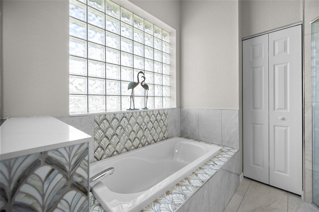 1950 Arkansas Avenue Englewood, FL 34224 - Photo 23 of 52 a bathroom with a tub and shower