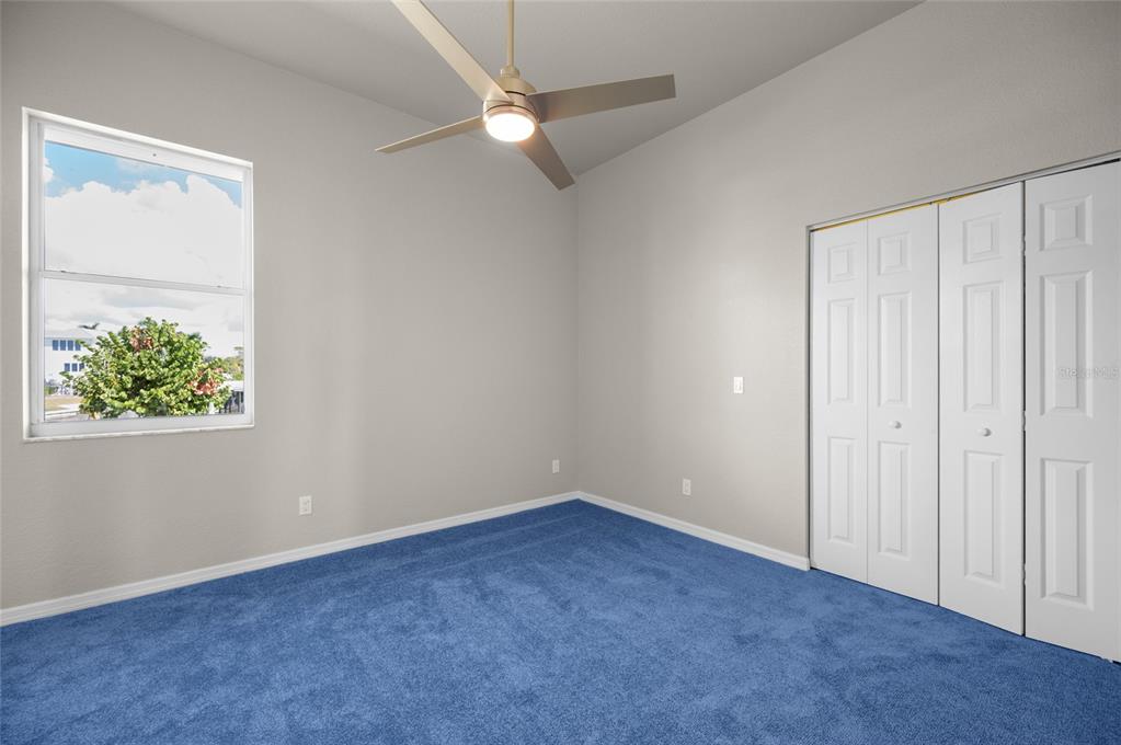 1950 Arkansas Avenue Englewood, FL 34224 - Photo 27 of 52 an empty room with a window and a ceiling fan