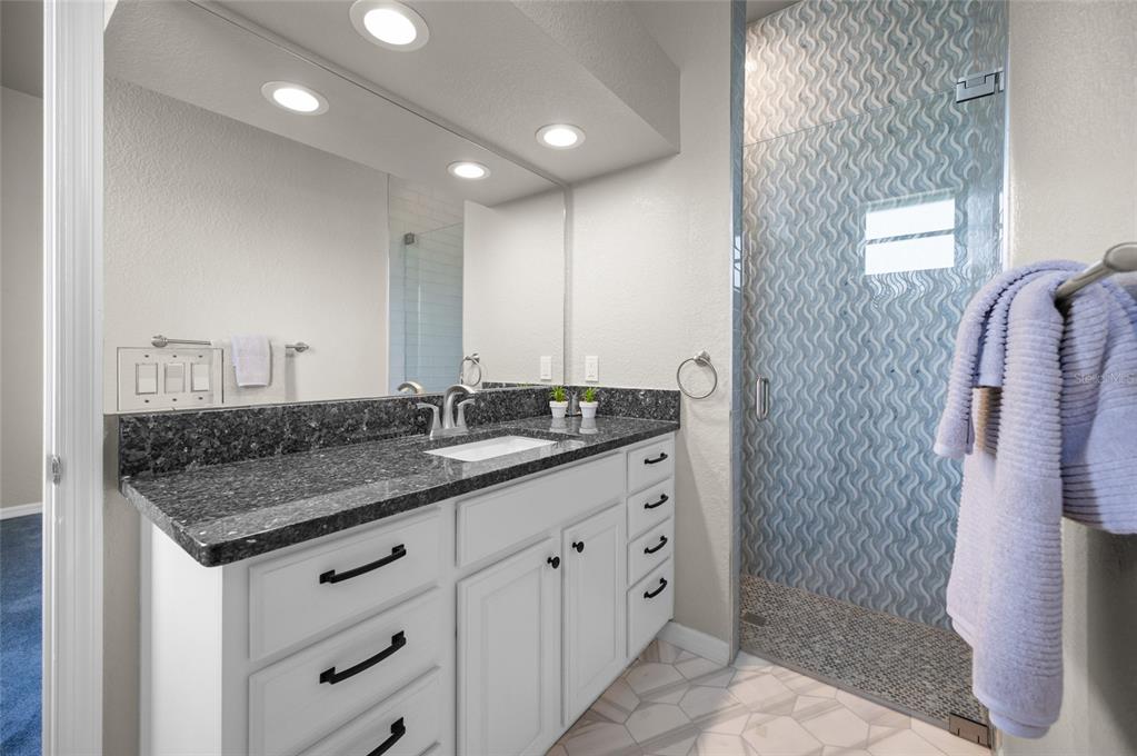 1950 Arkansas Avenue Englewood, FL 34224 - Photo 29 of 52 a bathroom with double sink and a mirror