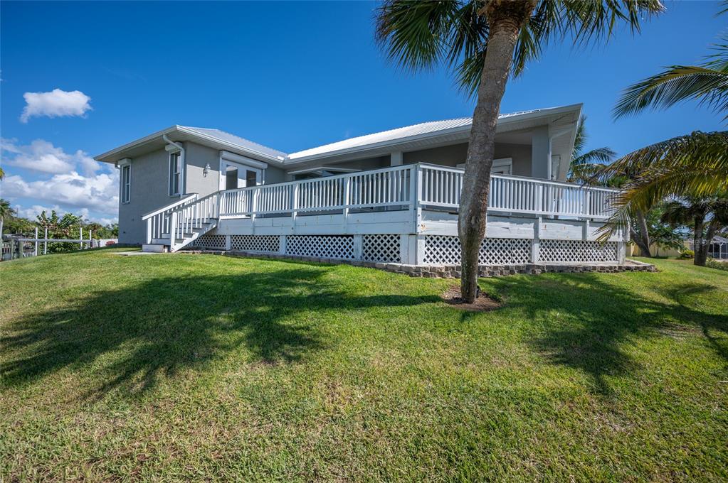 1950 Arkansas Avenue Englewood, FL 34224 - Photo 38 of 52 a house that has a big yard with wooden fence