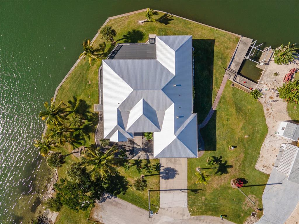 1950 Arkansas Avenue Englewood, FL 34224 - Photo 49 of 52 an aerial view of a house with a yard and wooden fence