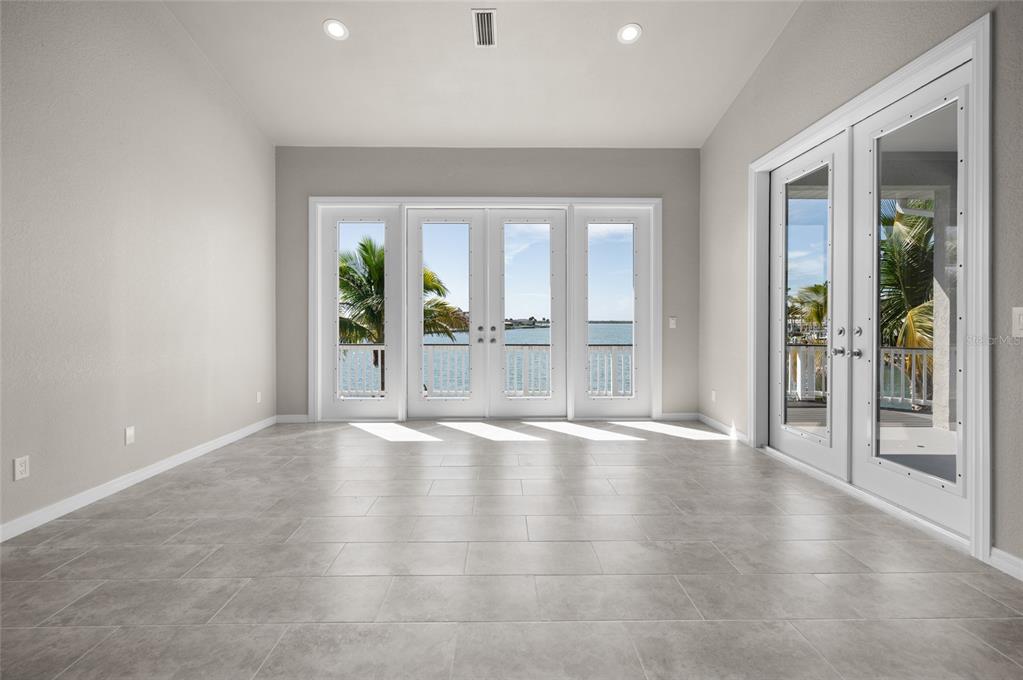 1950 Arkansas Avenue Englewood, FL 34224 - Photo 8 of 52 wooden floor in an empty room with a window