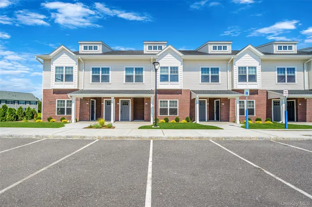 a front view of a building with a yard