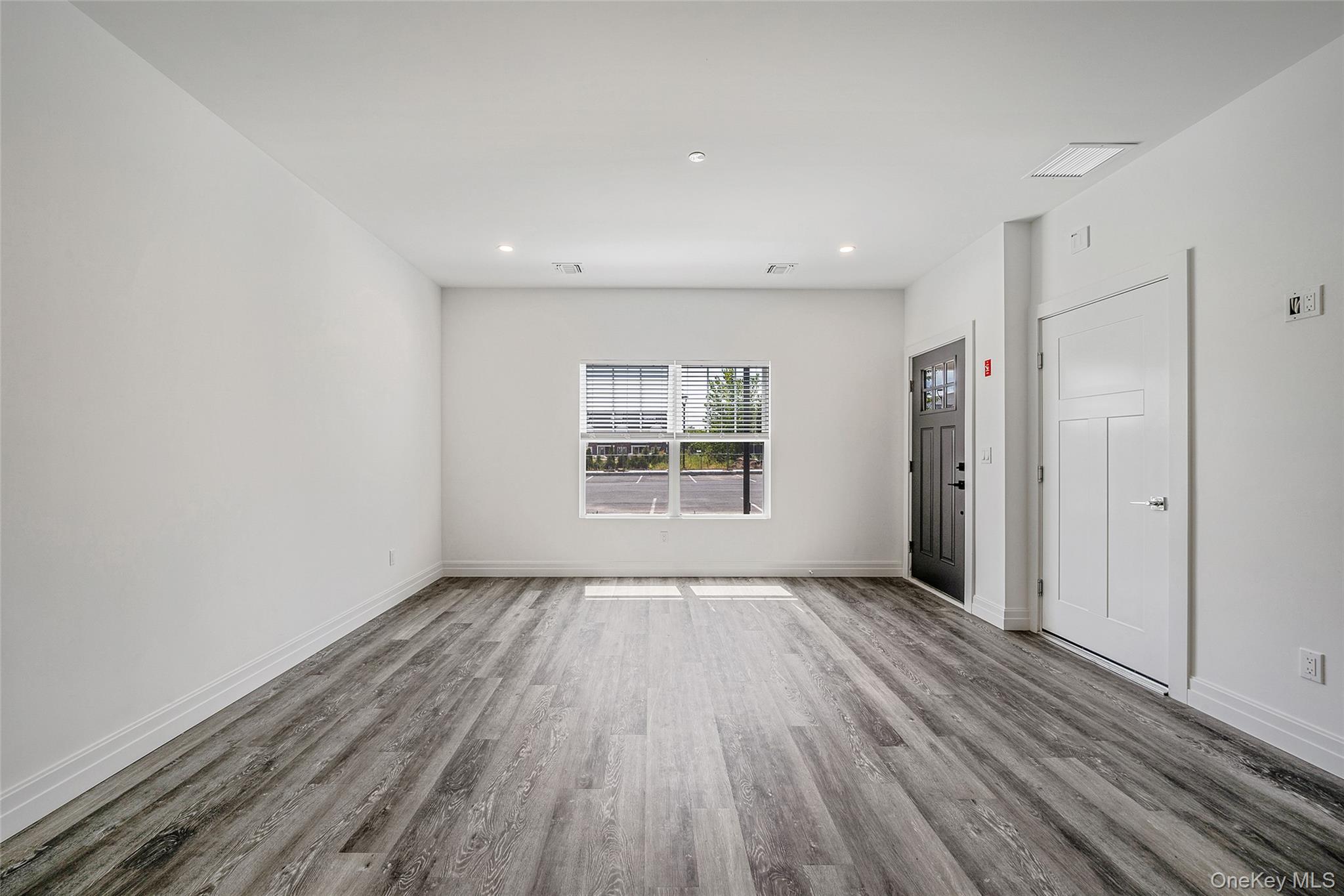 103 Dover Street Central Islip, NY 11722 - Photo 10 of 45 Unfurnished room with wood finished floors and recessed lighting
