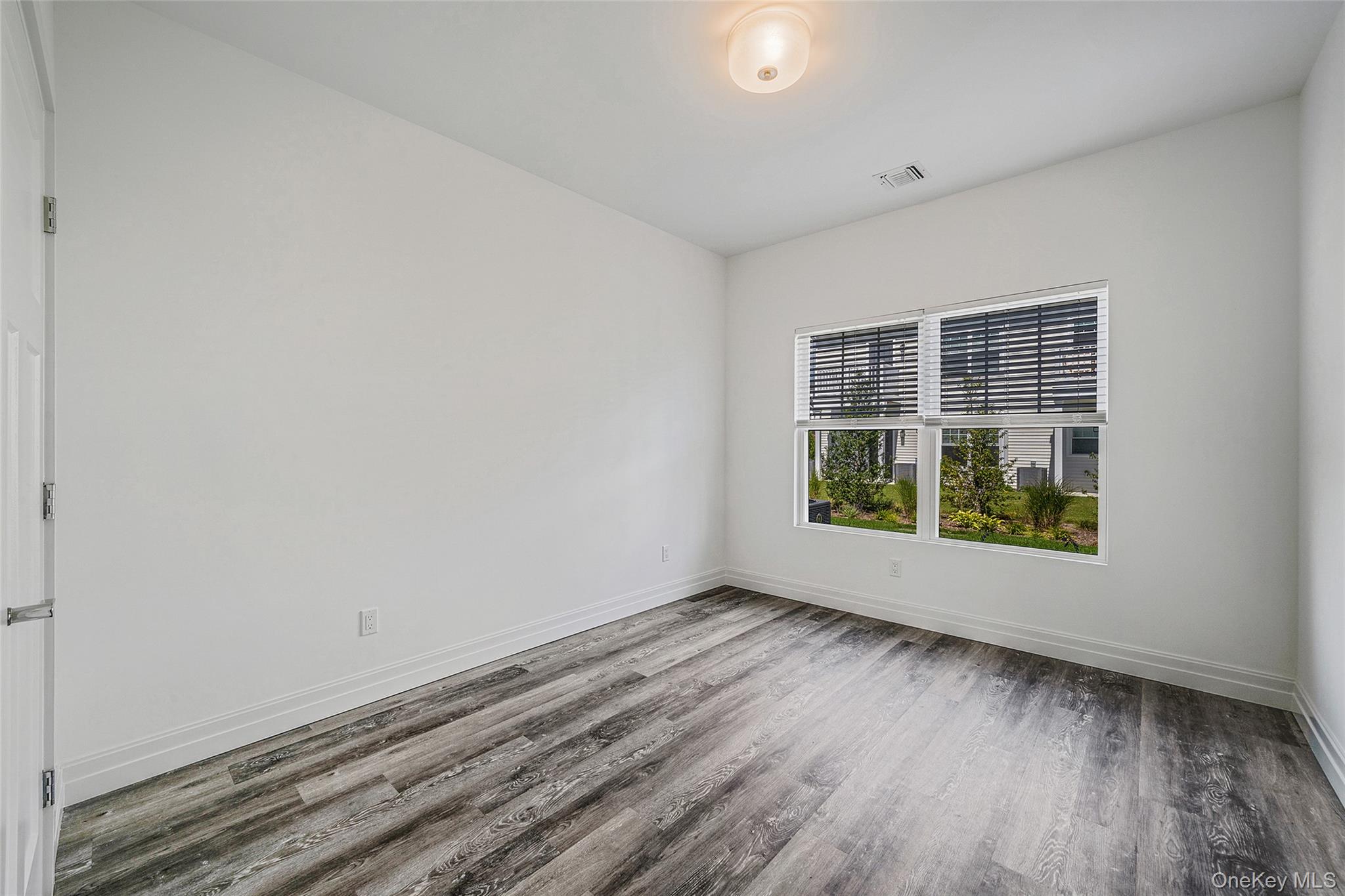 103 Dover Street Central Islip, NY 11722 - Photo 16 of 45 Spare room with wood finished floors and baseboards