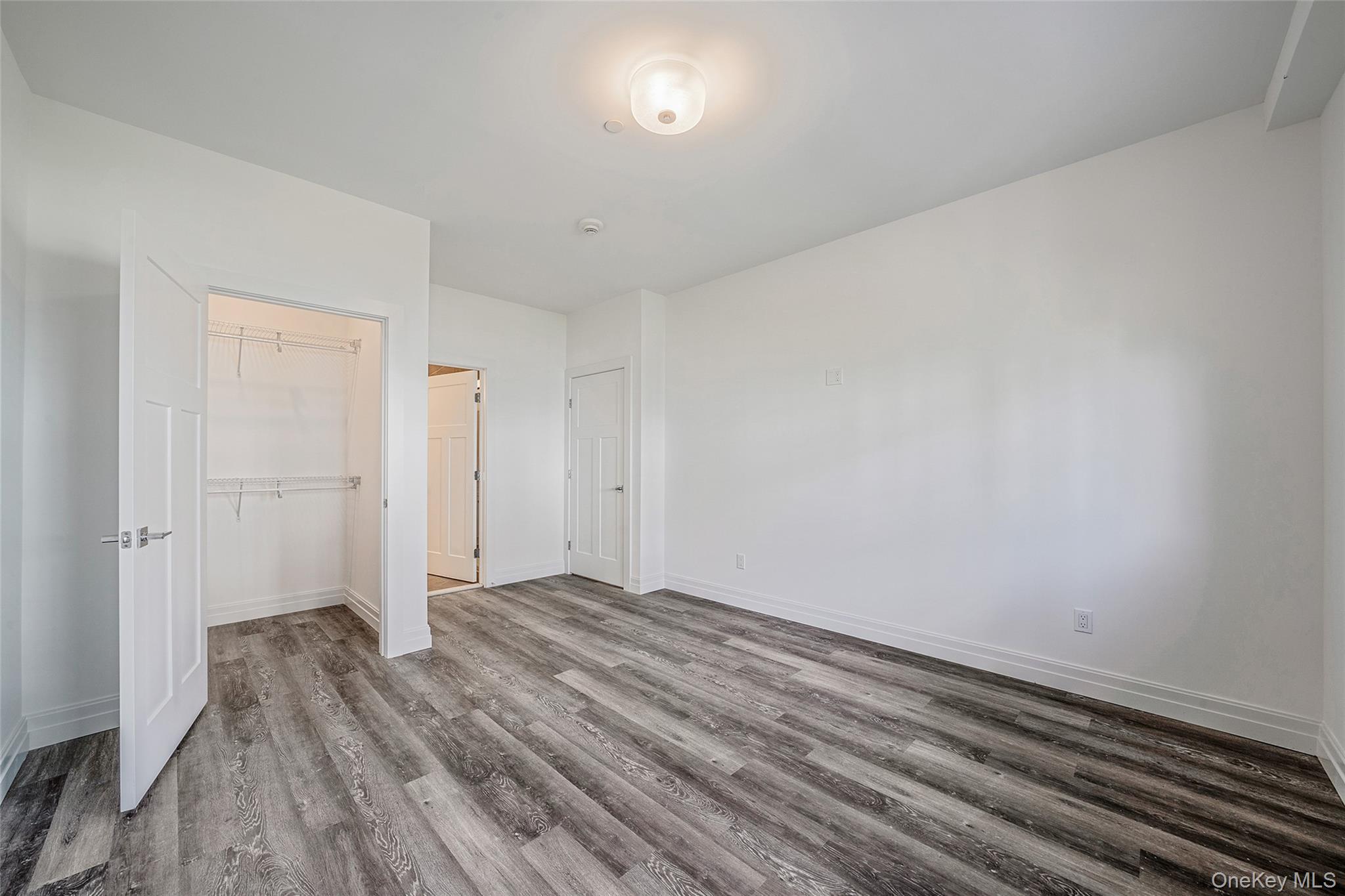 103 Dover Street Central Islip, NY 11722 - Photo 19 of 45 Unfurnished bedroom with wood finished floors and a closet