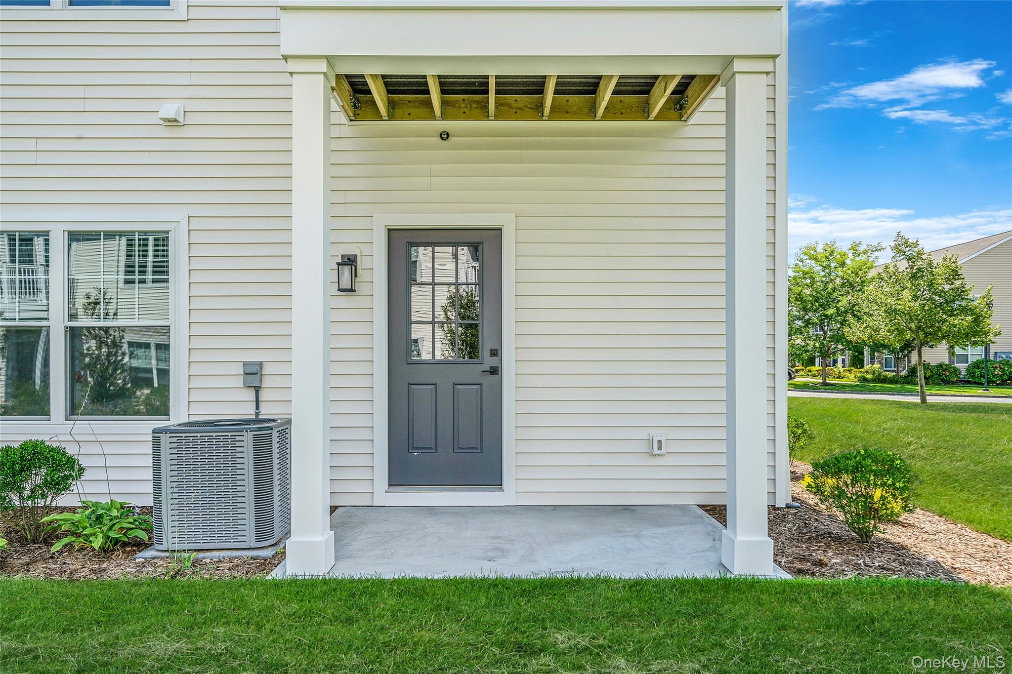 103 Dover Street Central Islip, NY 11722 - Photo 23 of 45 View of exterior entry featuring a yard and a patio