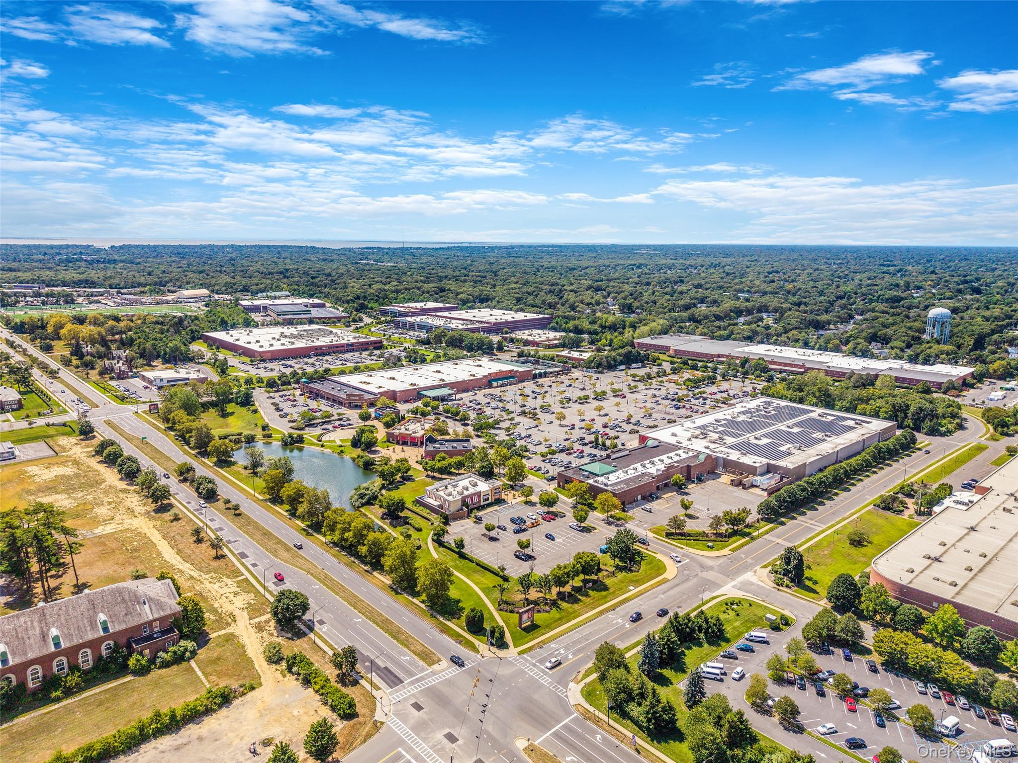 103 Dover Street Central Islip, NY 11722 - Photo 35 of 45 Drone / aerial view of a commercial area and a tree filled landscape