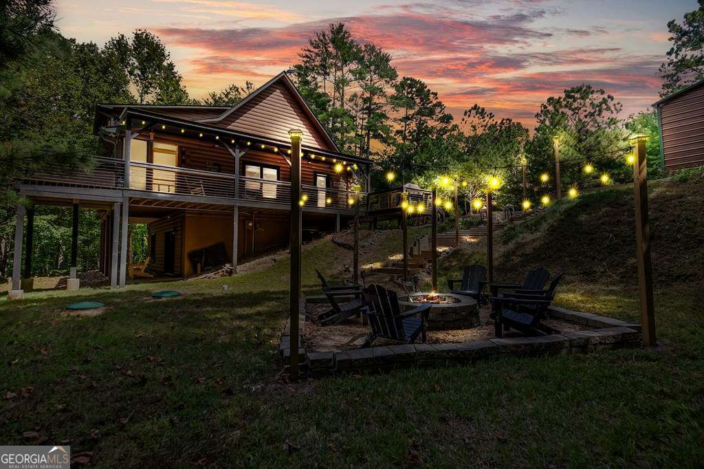 a view of a house with backyard next to a yard
