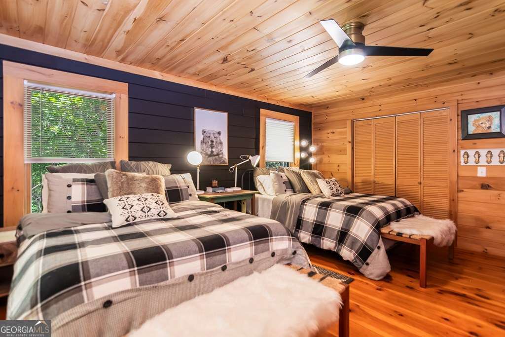 16 Toccoa Ridge Road, Unit 8 Mineral Bluff, GA 30559 - Photo 18 of 35 a bedroom with two beds and a large window