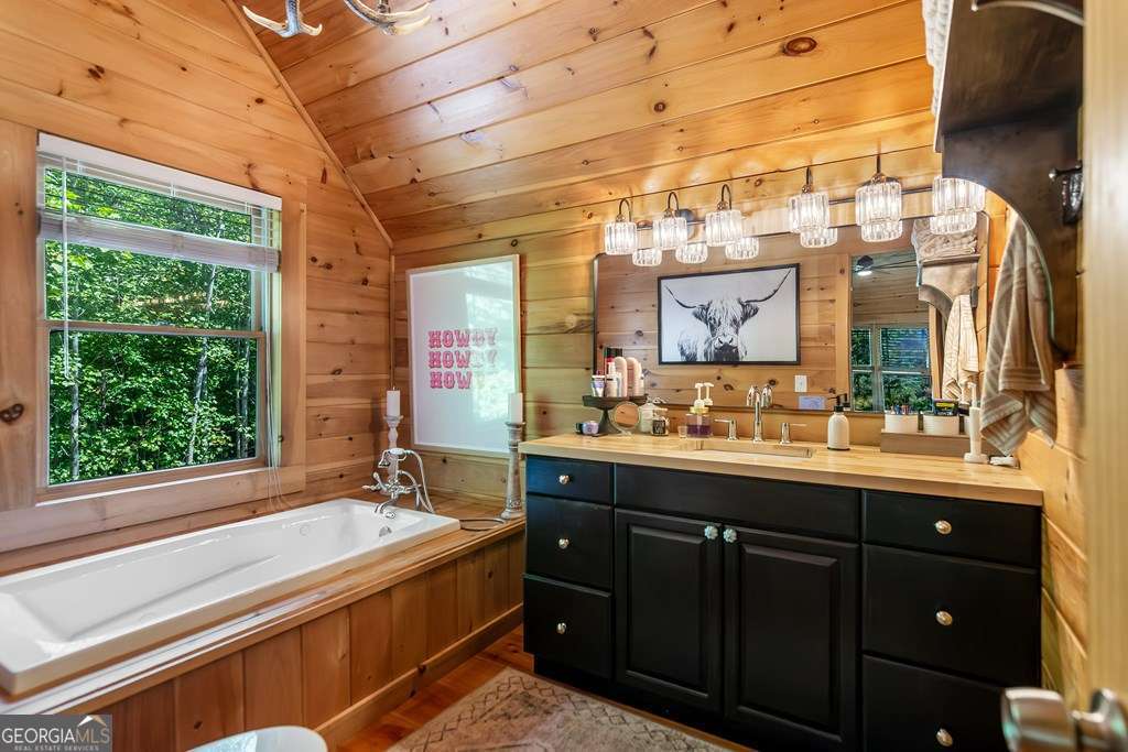 16 Toccoa Ridge Road, Unit 8 Mineral Bluff, GA 30559 - Photo 24 of 35 a spacious bathroom with a granite countertop sink and a large mirror