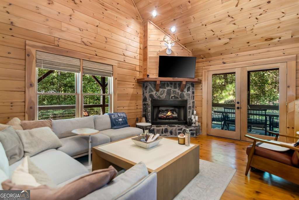 16 Toccoa Ridge Road, Unit 8 Mineral Bluff, GA 30559 - Photo 6 of 35 a living room with furniture a fireplace and a flat screen tv
