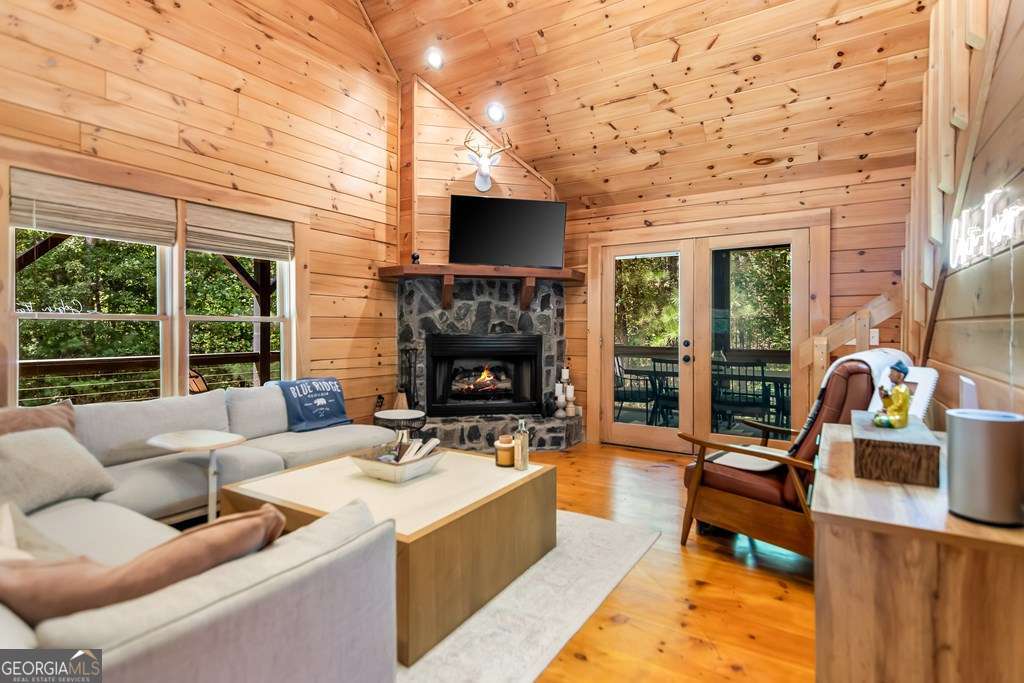 16 Toccoa Ridge Road, Unit 8 Mineral Bluff, GA 30559 - Photo 9 of 35 a living room with fireplace furniture and a flat screen tv