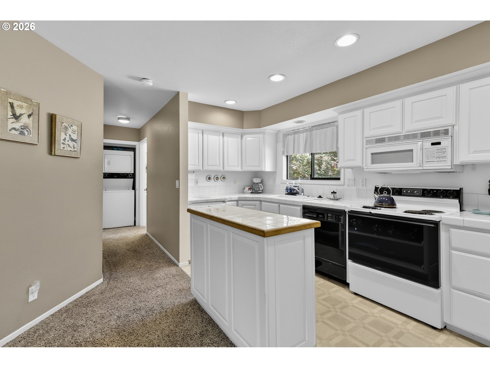 46725 Goodpasture Road Vida, OR 97488 - Photo 19 of 48 a kitchen with stainless steel appliances granite countertop a stove top oven a sink and a refrigerator with white cabinets