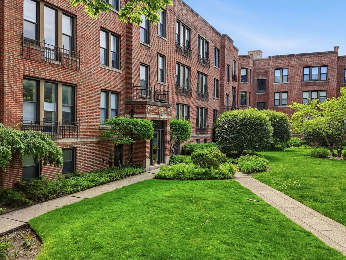 622 Judson Ave, Evanston IL &ndash; aerial view showing the building surrounded by tree canopy with Lake Michigan in the background