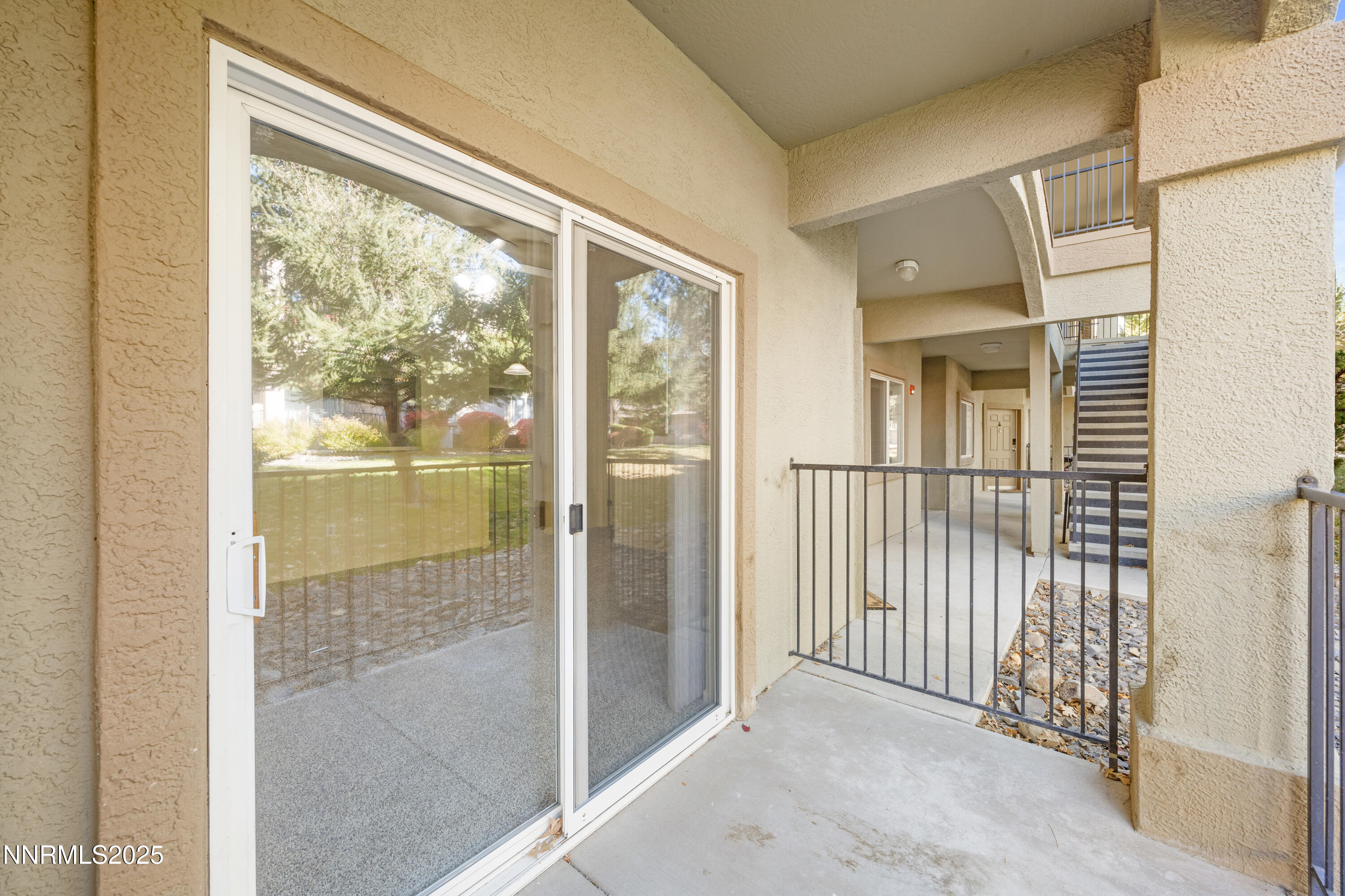 6850 Sharlands Avenue, Unit T1116 Reno, NV 89523 - Photo 21 of 26 a view of a glass door and a porch