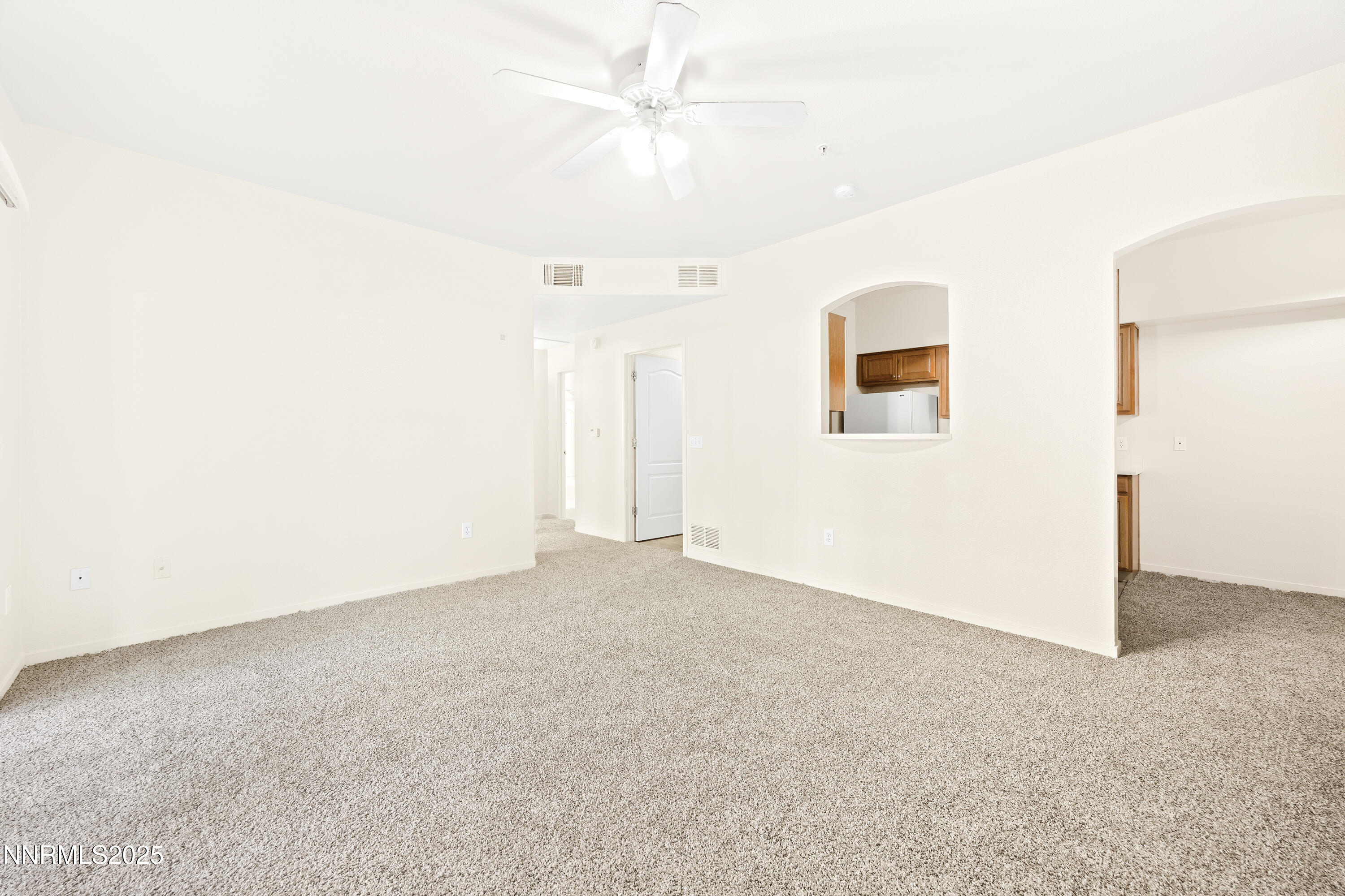 6850 Sharlands Avenue, Unit T1116 Reno, NV 89523 - Photo 5 of 26 an empty room with a ceiling fan and a window