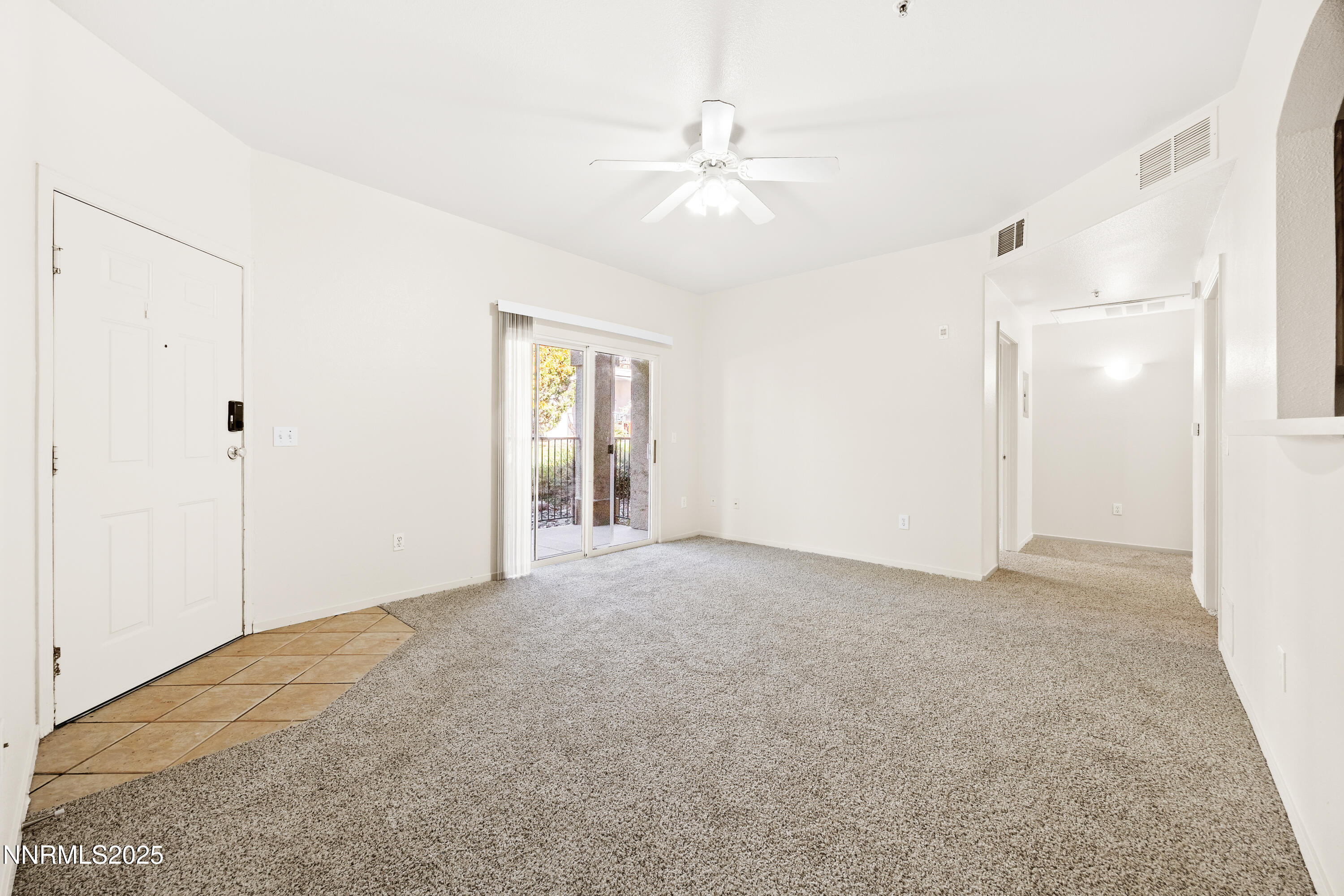 6850 Sharlands Avenue, Unit T1116 Reno, NV 89523 - Photo 6 of 26 a view of an empty room with chandelier fan