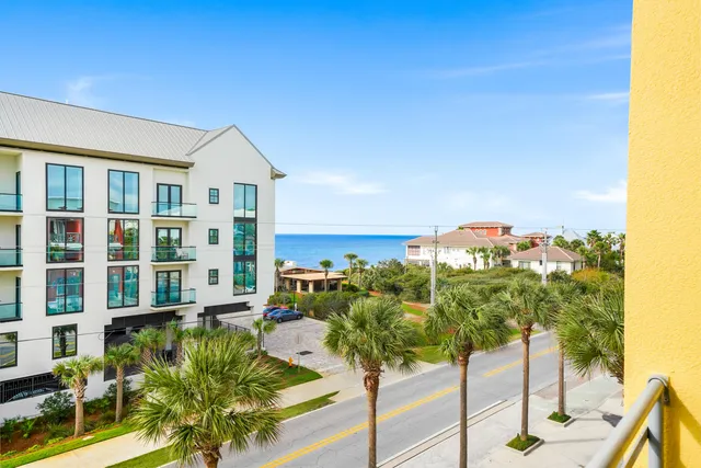 a view of a balcony with chairs and wooden floor