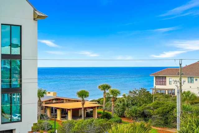 a front view of a multi story building with yard